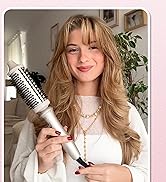 à brosse ronde blanche tenu par une personne portant un pull blanc, mettant en valeur le design du produit pour les soins capillaires.